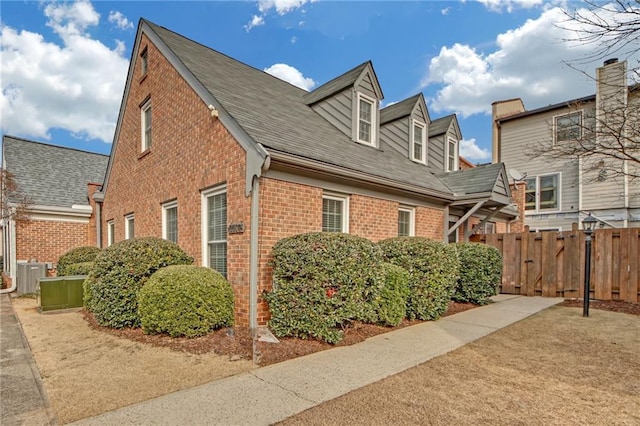 view of side of home with central AC unit