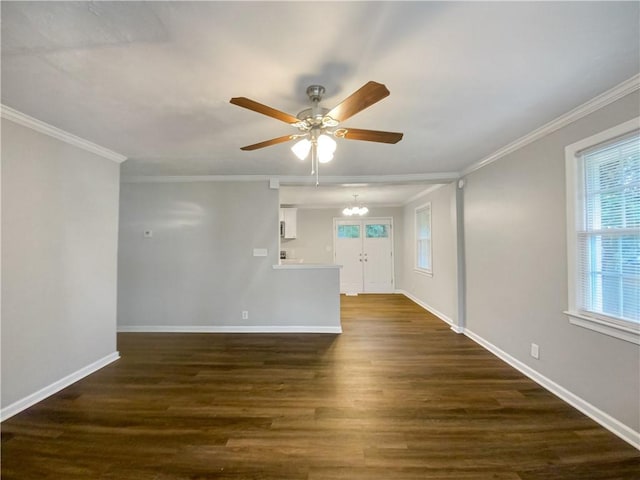 spare room featuring ceiling fan with notable chandelier, dark hardwood / wood-style flooring, and crown molding