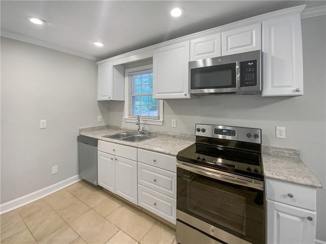 kitchen featuring sink, stainless steel appliances, white cabinetry, and light tile patterned floors