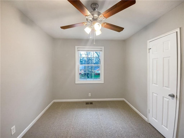 carpeted spare room with ceiling fan