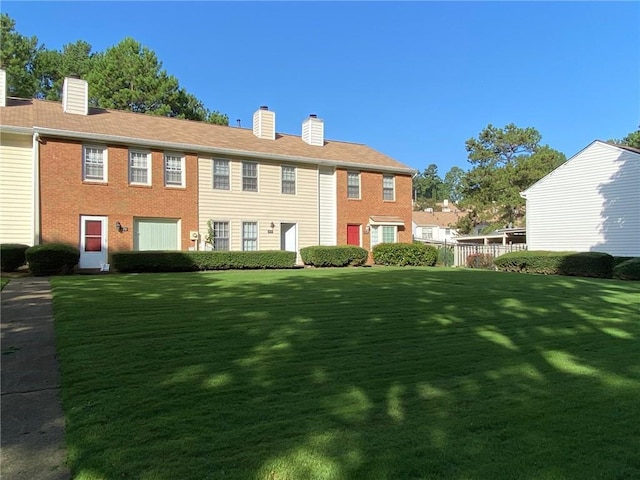 rear view of property with a lawn