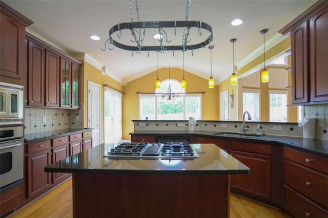 kitchen with plenty of natural light, appliances with stainless steel finishes, decorative light fixtures, and a chandelier