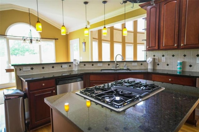 kitchen featuring decorative backsplash, stainless steel appliances, dark stone countertops, vaulted ceiling, and pendant lighting