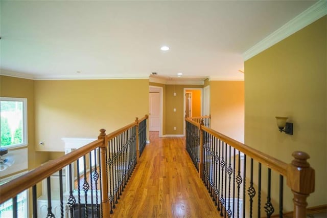 hall with crown molding and light hardwood / wood-style floors