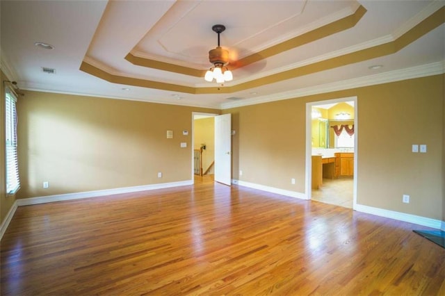 unfurnished room featuring light hardwood / wood-style flooring, ornamental molding, and plenty of natural light