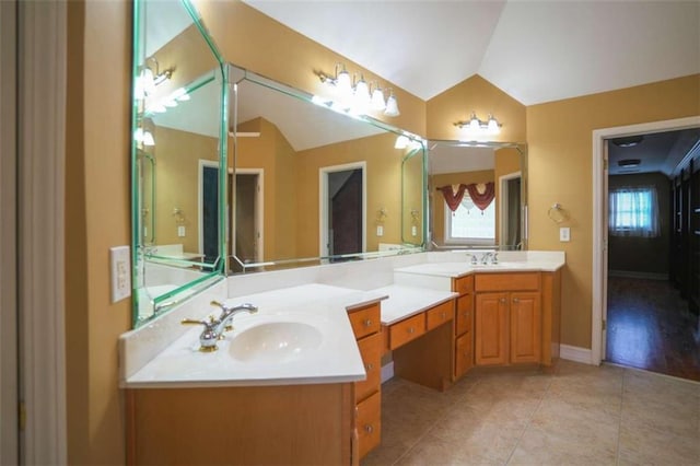 bathroom featuring vanity, vaulted ceiling, and tile patterned flooring