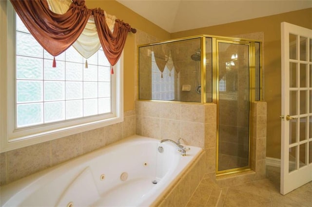 bathroom with independent shower and bath and tile patterned flooring