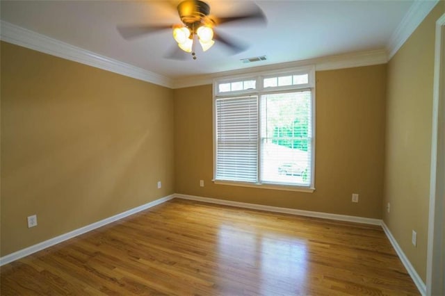 empty room featuring light hardwood / wood-style floors, ornamental molding, and ceiling fan