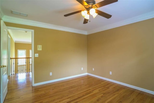 spare room featuring ornamental molding, wood-type flooring, and ceiling fan