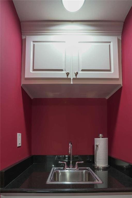 kitchen with white cabinetry and sink