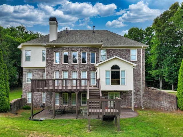 back of property with a yard, a patio, and a deck