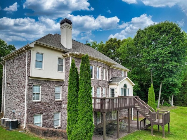 back of house with a patio area, a deck, and a lawn