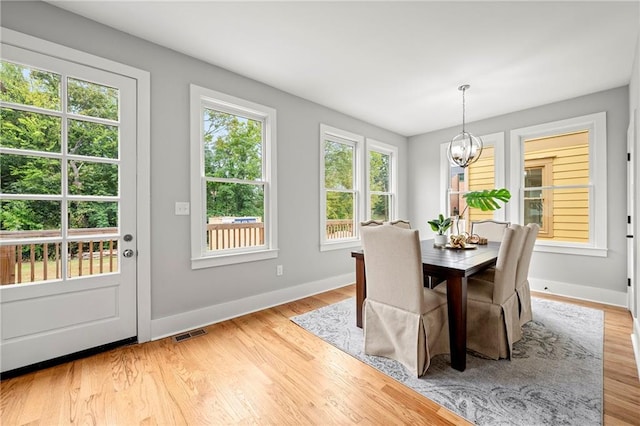 106 Hogue St, Atlanta, GA 30312 - dining room featuring a chandelier, baseboards, and light wood-style flooring