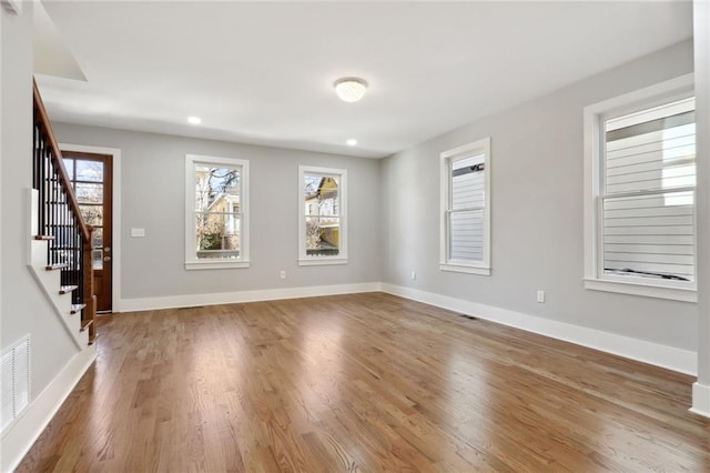 106 Hogue St, Atlanta, GA 30312 - spare room with healthy amount of natural light, wood finished floors, stairs, and recessed lighting