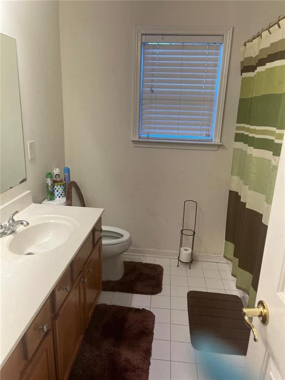 947 Simonton View Ln, Lawrenceville, GA 30045 - bathroom featuring tile patterned flooring, vanity, toilet, baseboards, and a shower with curtain