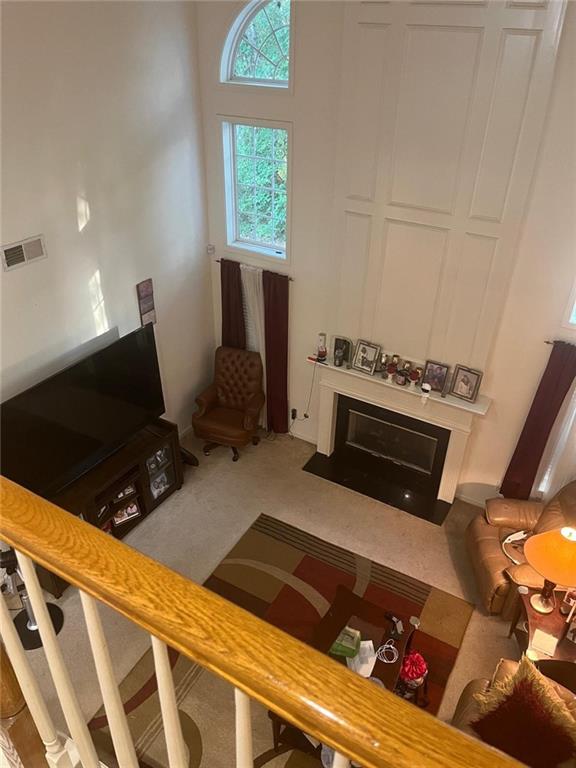 947 Simonton View Ln, Lawrenceville, GA 30045 - living room with a fireplace with flush hearth and carpet flooring