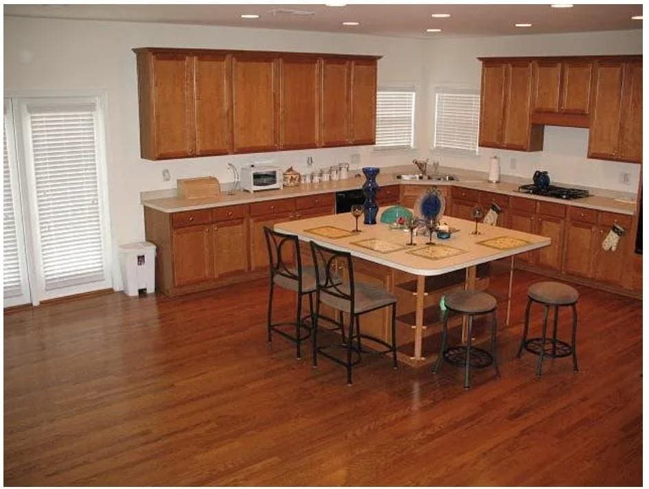 kitchen with brown cabinetry, stainless steel gas cooktop, and recessed lighting