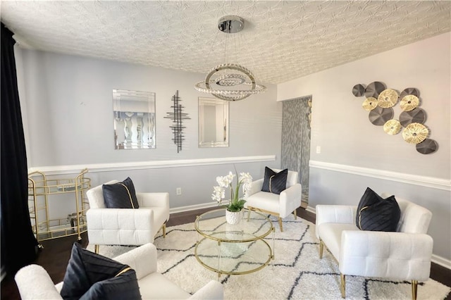 sitting room with hardwood / wood-style floors and a textured ceiling