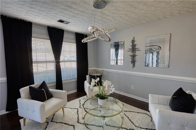 living area featuring dark hardwood / wood-style flooring and a textured ceiling