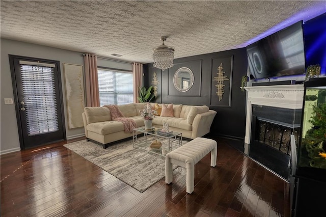 living room featuring dark hardwood / wood-style floors and a textured ceiling