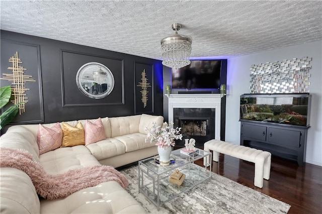 living room featuring dark hardwood / wood-style flooring, a chandelier, and a textured ceiling