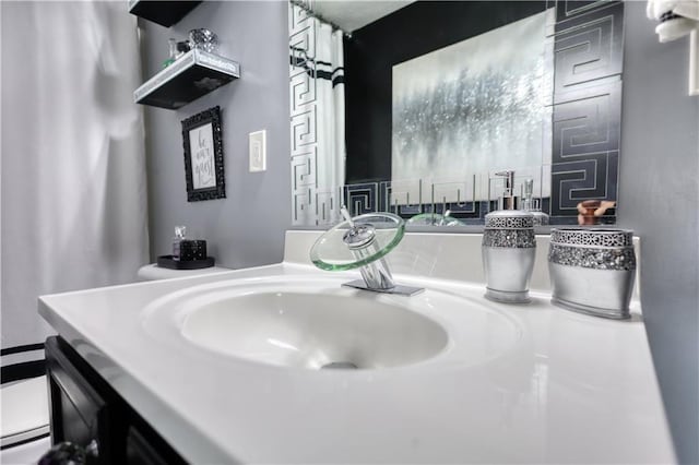 bathroom featuring vanity and toilet