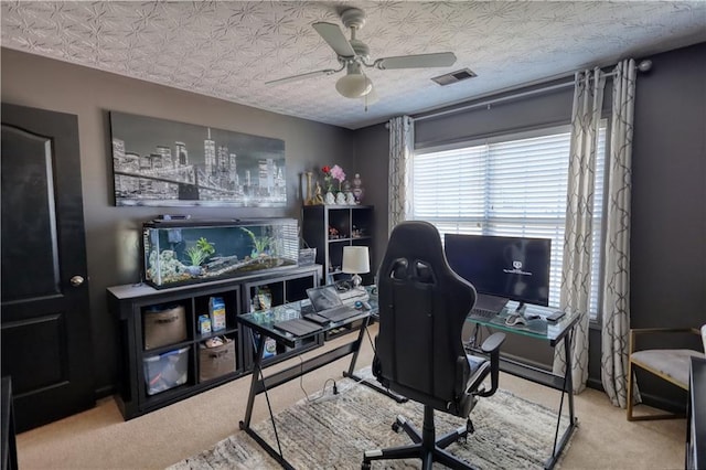 office area with a textured ceiling and ceiling fan