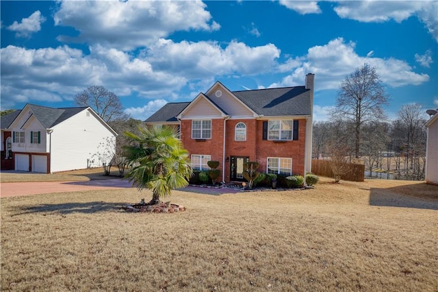 view of front of home with a garage and a front yard