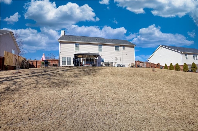 back of house with a yard and a carport