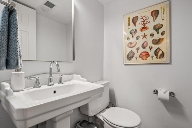 half bath with a sink and toilet