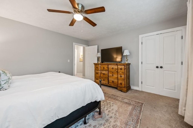 bedroom with carpet, ceiling fan, and a closet