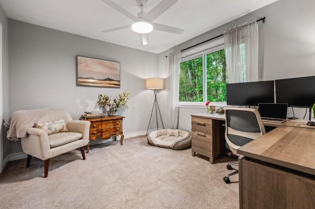office featuring light carpet, a ceiling fan, and baseboards