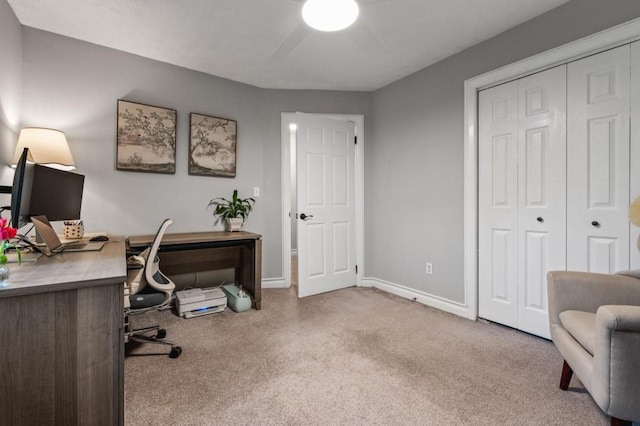 carpeted office featuring a ceiling fan and baseboards