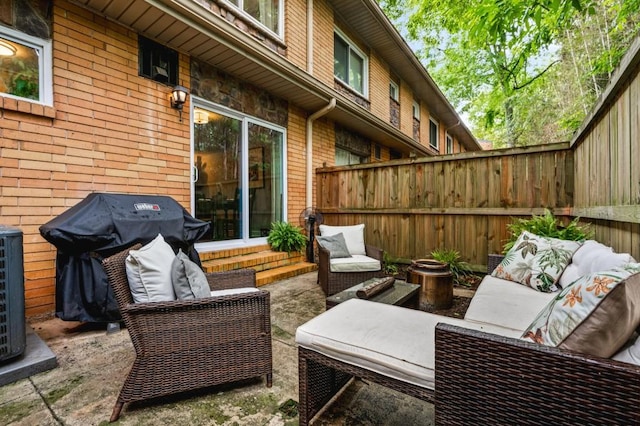 view of patio with fence, a grill, and an outdoor living space