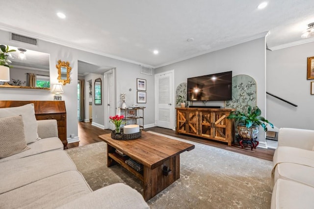 living area with crown molding, recessed lighting, wood finished floors, and baseboards