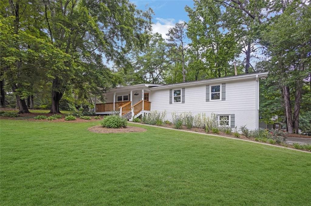 5666 Fawn Dr, Powder Springs, GA 30127 - ranch-style house featuring a front yard and a wooden deck