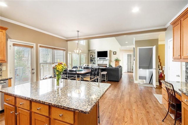 kitchen with light wood finished floors, open floor plan, and crown molding