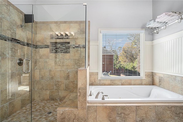 bathroom featuring a whirlpool tub and a stall shower