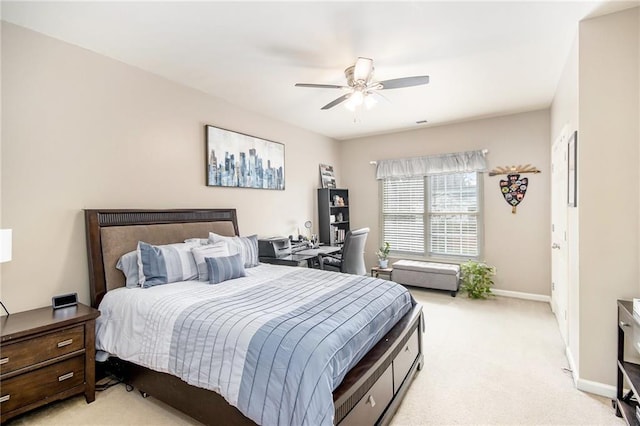 bedroom with light carpet, a ceiling fan, and baseboards