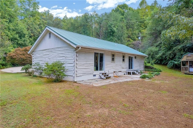 168 Silver Fox Dr, Dawsonville, GA 30534 - back of house featuring a patio, metal roof, a yard, and a forest view