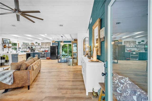 168 Silver Fox Dr, Dawsonville, GA 30534 - living area featuring light wood-style floors, a ceiling fan, beamed ceiling, and beverage cooler