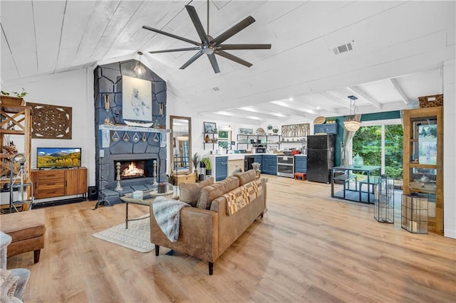 168 Silver Fox Dr, Dawsonville, GA 30534 - living room with light wood finished floors, a ceiling fan, lofted ceiling, and a large fireplace