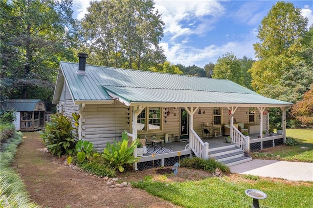 168 Silver Fox Dr, Dawsonville, GA 30534 - view of front of home with covered porch, log siding, and metal roof