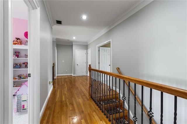 895 Ovalene Ln SW, Marietta, GA 30064 - hall featuring wood finished floors, visible vents, recessed lighting, an upstairs landing, and crown molding