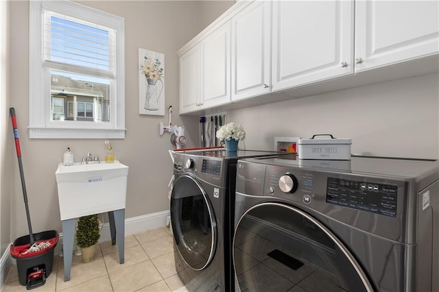 895 Ovalene Ln SW, Marietta, GA 30064 - clothes washing area with baseboards, independent washer and dryer, light tile patterned floors, and cabinet space