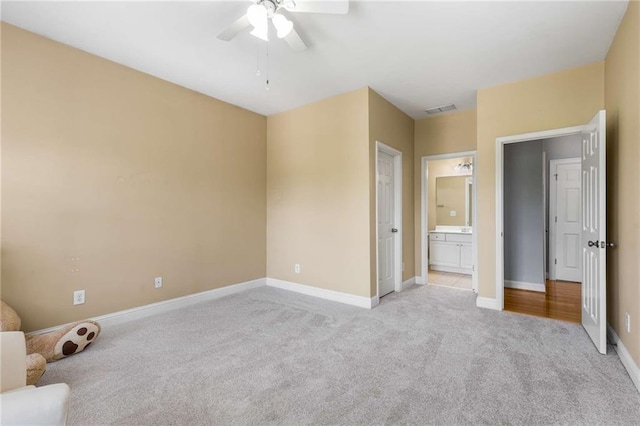 895 Ovalene Ln SW, Marietta, GA 30064 - unfurnished bedroom with baseboards, ensuite bath, ceiling fan, visible vents, and light carpet