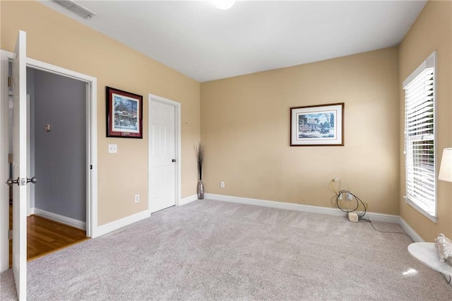 895 Ovalene Ln SW, Marietta, GA 30064 - unfurnished bedroom with baseboards, multiple windows, and carpet