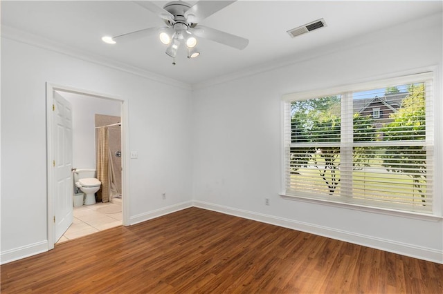 895 Ovalene Ln SW, Marietta, GA 30064 - unfurnished bedroom with wood finished floors, ornamental molding, visible vents, connected bathroom, and baseboards