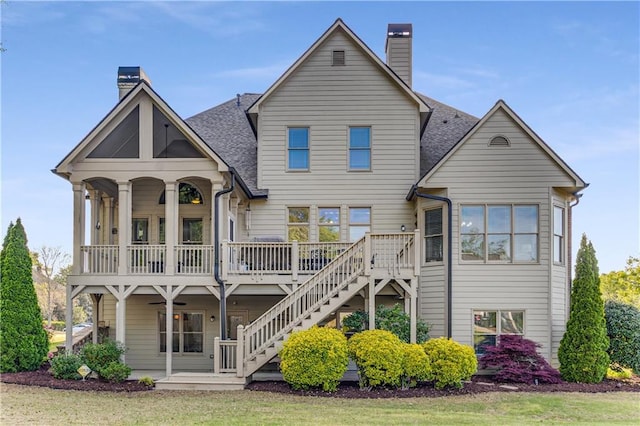 895 Ovalene Ln SW, Marietta, GA 30064 - back of property featuring stairway, roof with shingles, covered porch, and a chimney