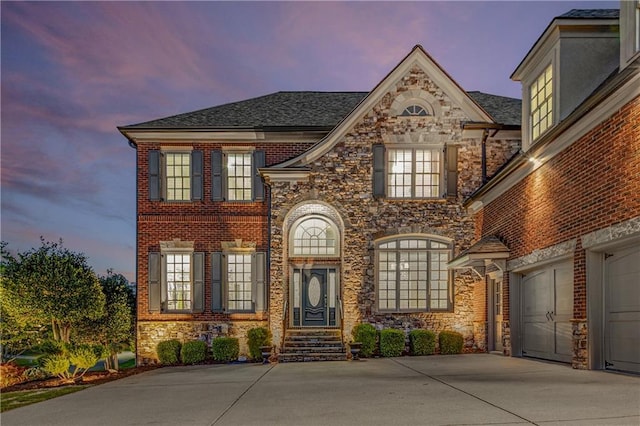 895 Ovalene Ln SW, Marietta, GA 30064 - view of front of property featuring driveway, a garage, and stone siding